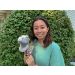 Woman holding Roaring T. rex plush