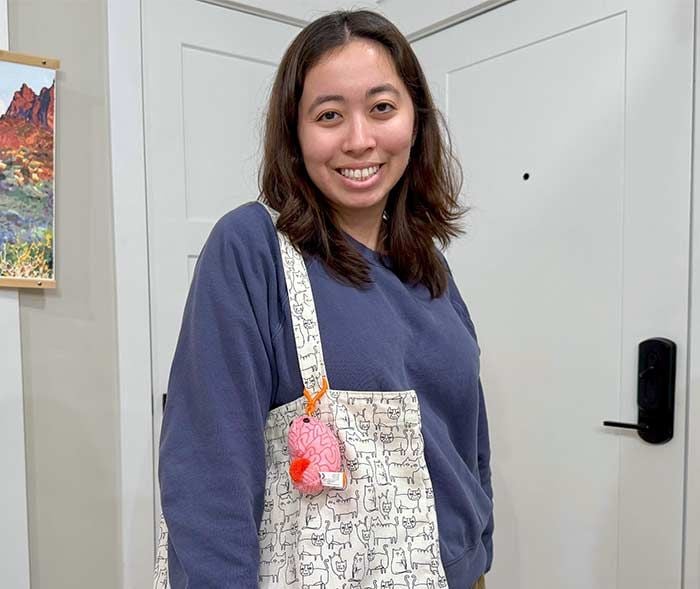 Brain key chain on bag with woman